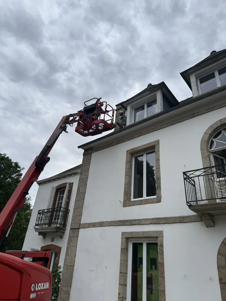 Dormer painting - PDV France Aerial lift raised to a dormer window during exterior painting for PDV France